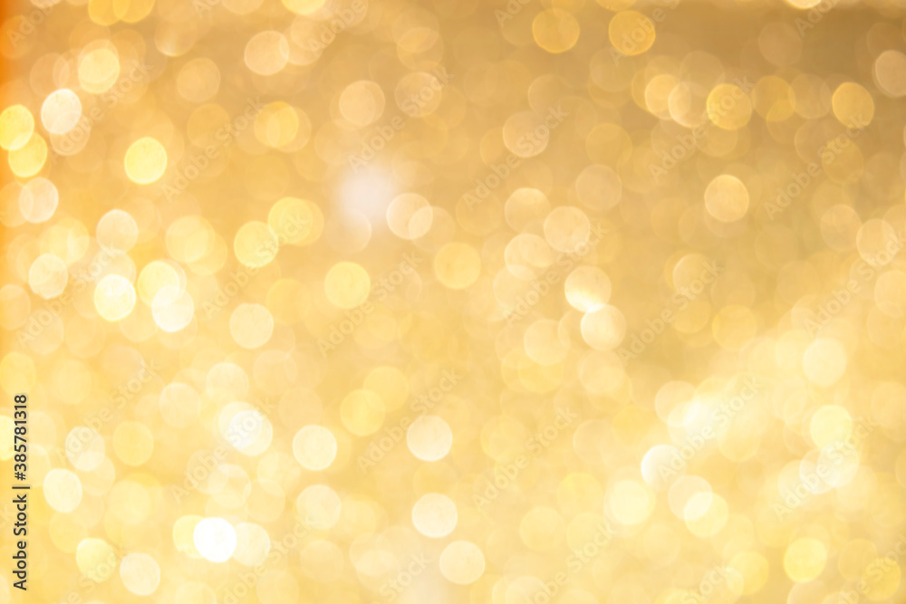 Wall mural gold light shiny bokeh abstract blur background with bright round defocus golden pattern, can use fo