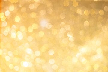 Gold light shiny bokeh abstract blur background with bright round defocus golden pattern, can use...