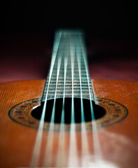 Obraz premium Spanish guitar lying on a bed with depth of field