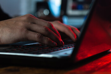 a man working in a laptop close-up, hands on the keyboard,