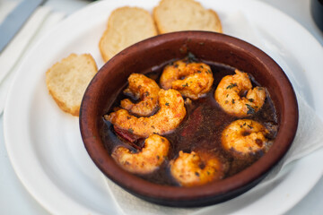 Spanish cuisine gambas pil pil in Andalusia region of south Spain. delicious shrimp in rich spicy sauce and toasted bread