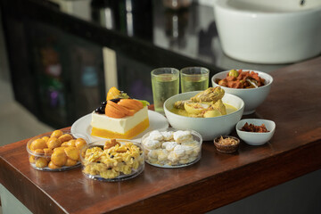 A wide variety of special dishes to celebrate Eid, cakes, cookies with pineapple filling, syrup drinks, and Chicken Opor