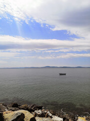 lonely boat in the sea sea shore with a stone embankment
