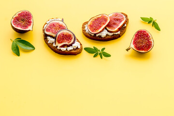 Toasted bread with figs, cheese and honey on table