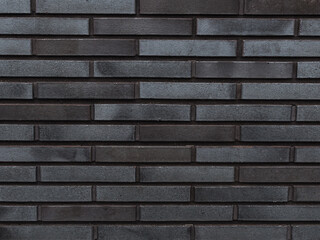 wall of dark gray brick - texture closeup