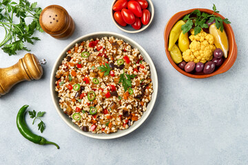 Bulgur pilaf with eggplant and vegetables. Top view with copy space