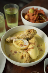 Chicken braised in coconut milk with turmeric called Opor Ayam. Signature dish for Eid Holiday.