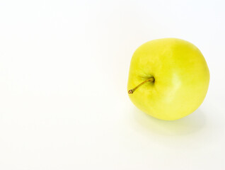 Ripe light green apple lying on its side isolated on white background