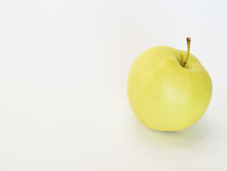 Juicy light green apple lying with the handle upwards, isolated on white background