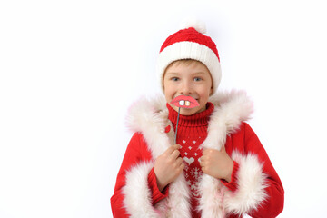 A child dressed as Santa Claus holds a funny lips on a stick prop.