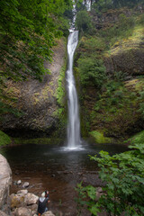 Tourist taking images of a waterfall in the Clearwater River Area
