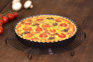 Homemade quiche lorraine with chicken, mushrooms and cheese. French cuisine.