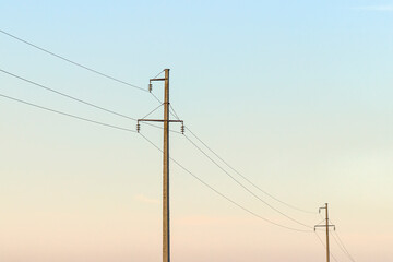 Power lines against the blue sky. Electrical equipment with copy space. High voltage wires in the...