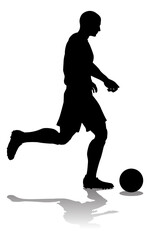 A soccer or football player in silhouette