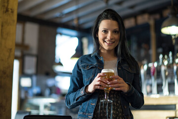Pretty woman in bar drinking beer