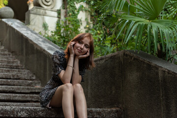 Portrait of a young girl in a green park