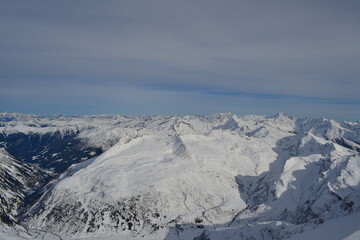 Fototapeta na wymiar Picturesque winter mountains in a ski resort on snow-capped mountain peaks.