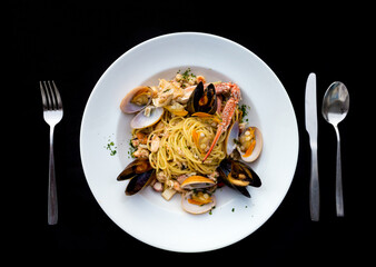 Italian Pasta spaghetti seafood with mussels and shrimps and tomatoes, with parsley