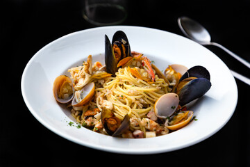 Italian Pasta spaghetti seafood with mussels and shrimps and tomatoes, with parsley