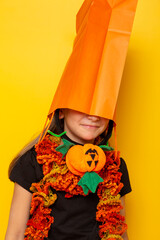 Little girl wearing shopping bag over head for Halloween