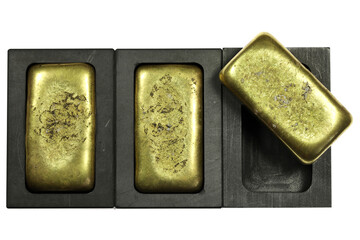 graphite molds with gold bars isolated on white background