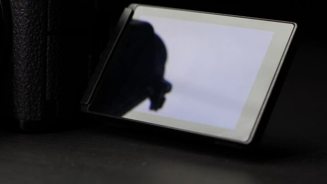Close Up of the new Panasonic Lumix S5 mirrorless cameras flippy screen. Shot in slow motion 4K in front of a black background with soft lighting.