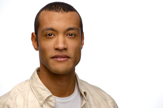 Portrait of young black man looking at camera with straight face 