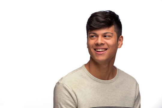 Portrait of young man of Latin decent looking off camera smiling