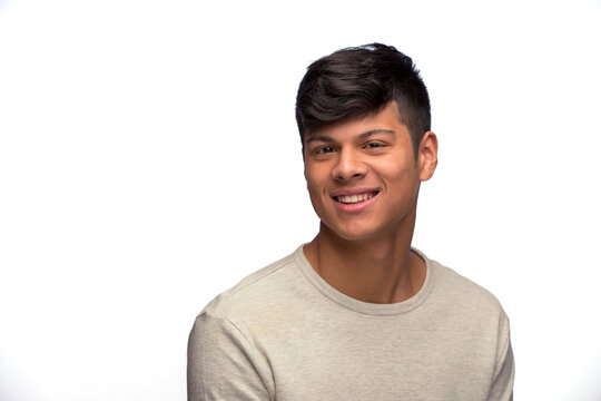 Portrait of young man of Latin decent looking at camera smiling