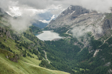 Lago Fedaia (Fedaia lake), an artificial lake and a dam near Canazei, located at the foot of Marmolada massif,  as seen from Viel del Pan refuge, Dolomites, Trentino, province of Belluno, Italy.
