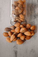 Almonds in a jar on wooden rustic table as background. Organic and healthy food. 