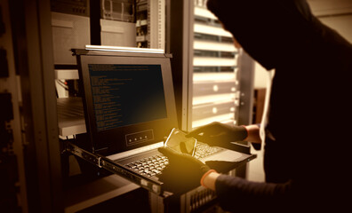 Hacker will hacking and steal data information in data center room. sepia, golden tone.