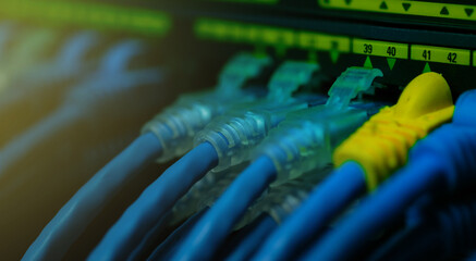 Network gigabit switch and UTP port cat 6 ethernet cables close-up in data server room