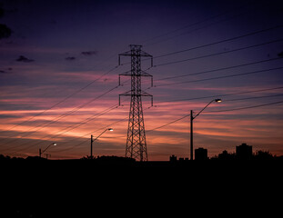 Fototapeta na wymiar High voltage electricity pylon over sunset