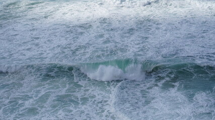 Wave in the middle of stormy sea foam