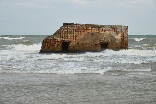 German bunker from World War II, the defensive structure is made of concrete, the building is surrounded by sea water. Denmark, Vigso.