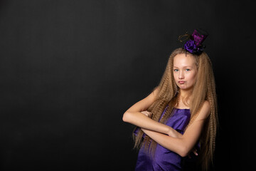 Teenage girl on black background of Halloween