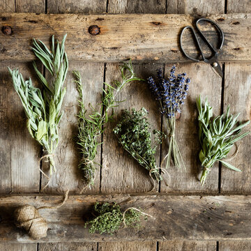Bundled herbs on wooden surface