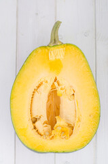 Half ripe butternut squash on wooden surface