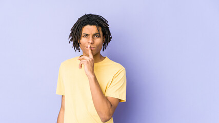 Young african american rasta man thinking and looking up, being reflective, contemplating, having a fantasy.