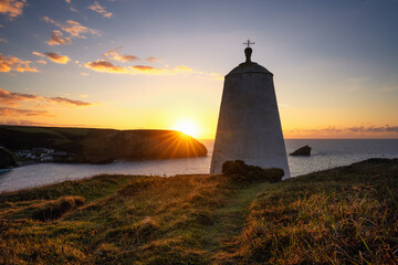The pepper pot at portreath at sunset Cornwall England uk with sunburst