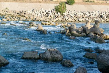 Rocks in the riverbed blue background summer