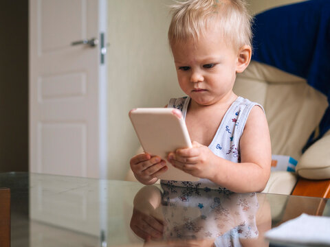 Cute Baby Looking At Smart Phone