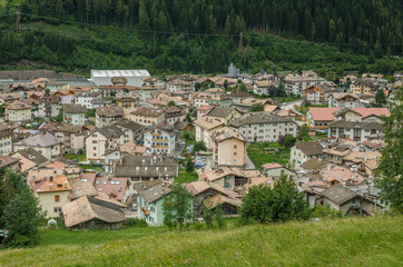 View of Predazzo village, located in Val di Fiemme, in a rainy day as seen from Bosca Fontana forest, Latemar mountain group, Dolomites, Trento province, Trentino, South Tirol, Italy.