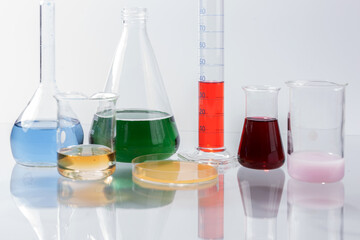 Glass laboratory apparatus with color water on the glass table