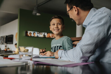 Father helping son with his homework
