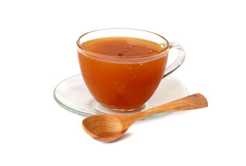 Honey in a glass cup with spoon isolated on white