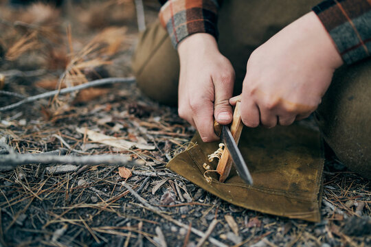 Bushcrafter preparing for campfire