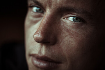 Close-up of mid adult man with blank expression against black background