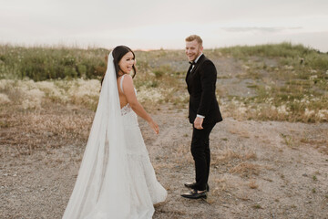 Smiling bridegroom standing in field